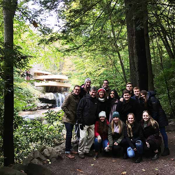 professor and students in front of Fallingwater