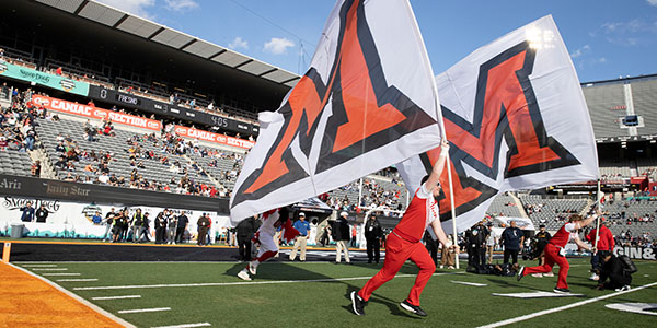 Miami University students with Miami flag at Arizona Bowl
