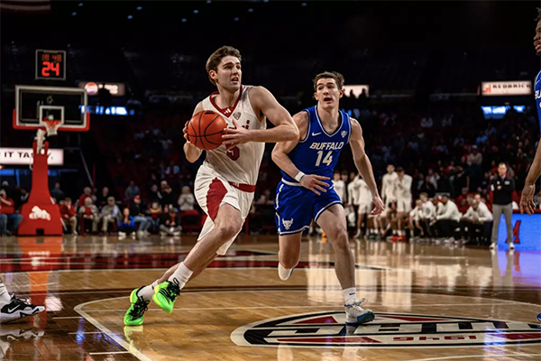 Miami University's Peter Suder drives to the basketball against Buffalo